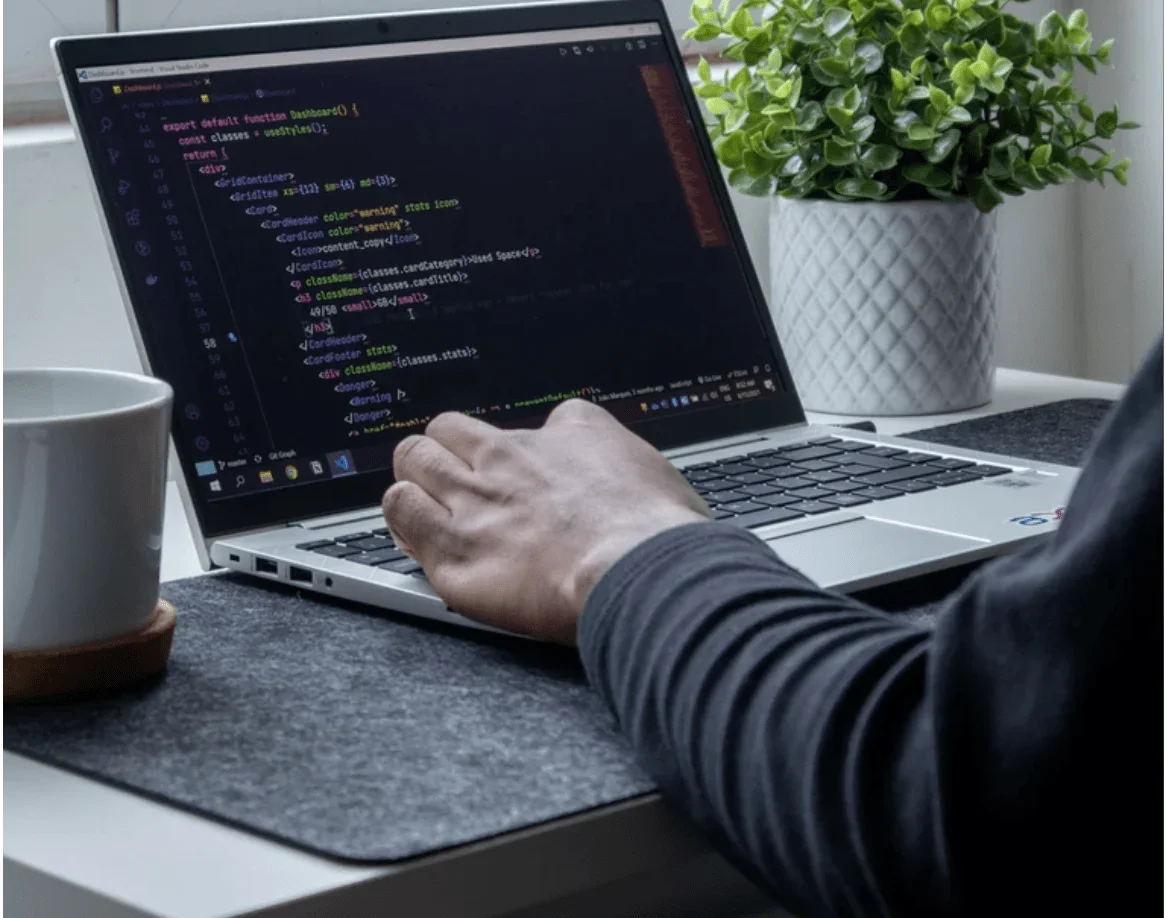 Someone coding at laptop