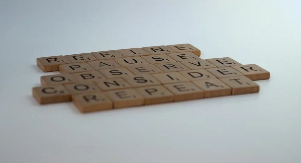 Brown scrabble pieces on a white table
