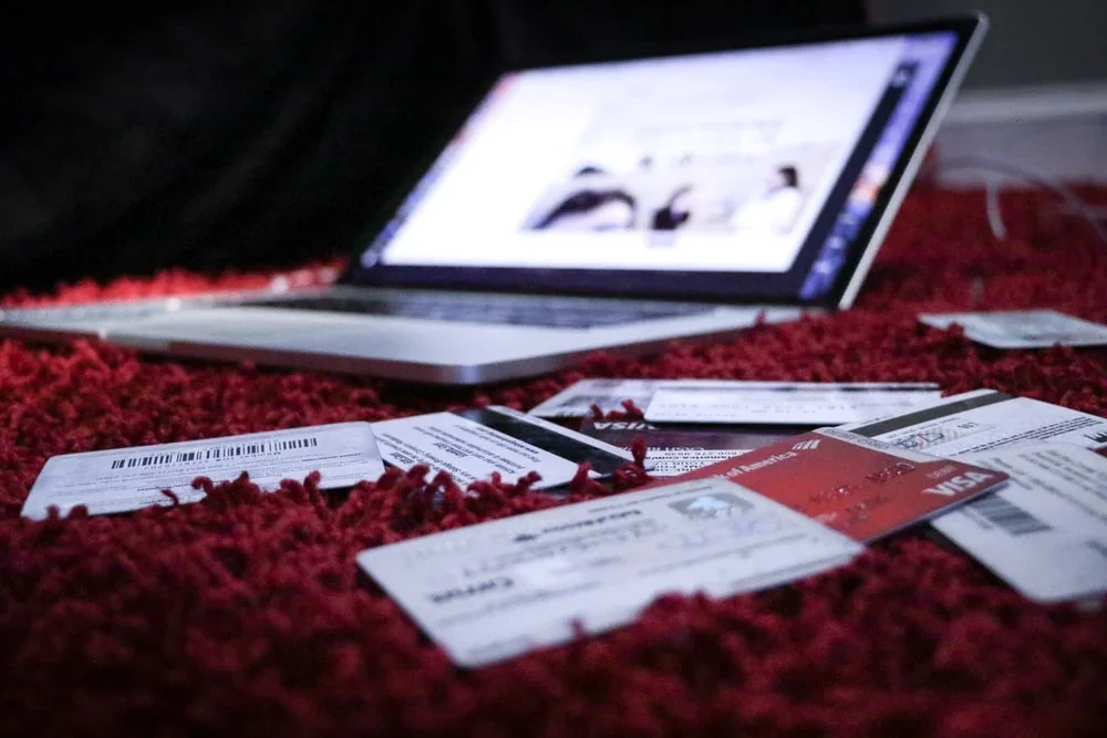 A computer with credit cards next to it